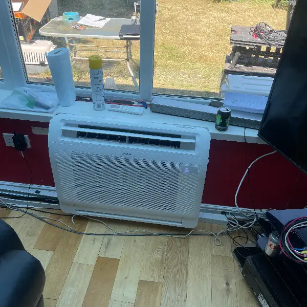 Floor-standing air conditioning unit Floor-standing air conditioning unit installed beneath a garden-facing window